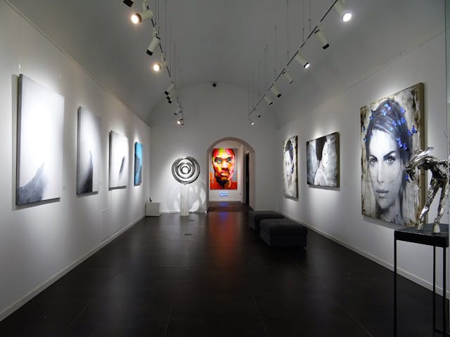 Art%20exhibit%20with%20various%20paintings%20on%20wall